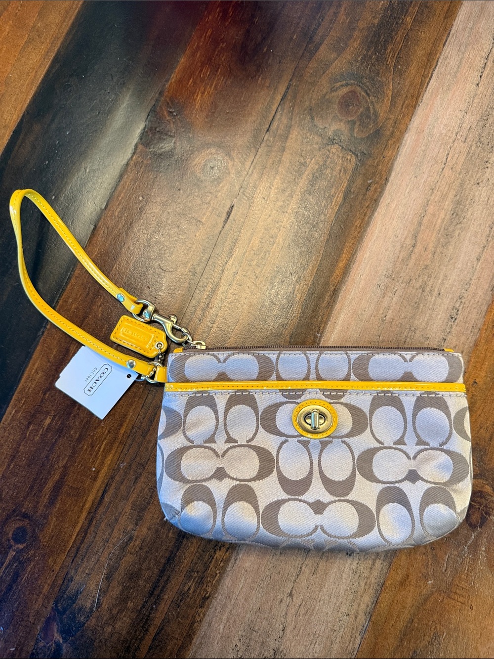 Coach Signature Wristlet with Yellow Trim and Turn-Lock. NWT